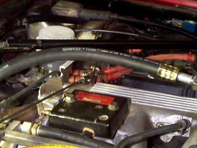 Low pressure freon line arching over throttle linkage